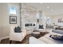 Bright living room featuring a modern fireplace and seating area with stylish decor and plenty of natural light at 4385 Carr St, Wheat Ridge, CO 80033