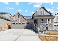 Charming home featuring a stone accented three car garage, covered porch and manicured lawn at 17163 Desert Wine Trl, Parker, CO 80134