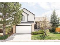Charming two-story home featuring a brick and siding exterior with an attached two-car garage at 1566 S Richfield Way, Aurora, CO 80017