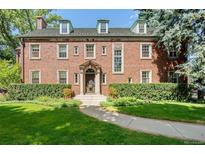 Brick home with landscaped lawn and walkway at 869 Vine St, Denver, CO 80206