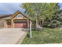 Charming home with a well-manicured lawn, stone accents, and a spacious three car garage at 1562 Suncrest Rd, Castle Rock, CO 80104
