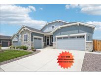 Beautiful single-Gathering home featuring a three-car garage, stone accents, and well-maintained landscaping at 15987 E 115Th Pl, Commerce City, CO 80022