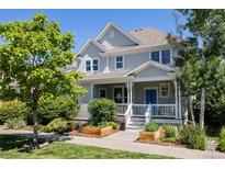 Charming two-story home with landscaped yard and inviting front porch, perfect for enjoying the outdoors at 10069 E 28Th Ave, Denver, CO 80238