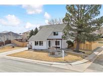 Charming two-story home with a landscaped yard and mature trees providing curb appeal at 6032 S Newport St, Centennial, CO 80111