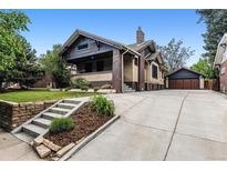 Charming brick home with landscaped front yard, long driveway, and detached garage at 3145 W 31St Ave, Denver, CO 80211