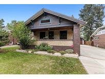 Charming bungalow-style home with well-maintained front yard and inviting front porch with brick and stone accents at 3145 W 31St Ave, Denver, CO 80211