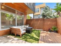 Cozy patio with modern seating, wood accents, and a neat outdoor space at 2640 Central Ct # 104, Denver, CO 80211