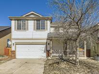 Charming two-story home featuring a well-kept lawn and a convenient attached two-car garage at 15047 E 50Th Dr, Denver, CO 80239