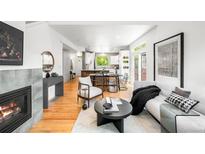 Inviting living room with fireplace, modern furnishings, and hardwood floors at 1947 King St, Denver, CO 80204
