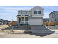 Charming two-story home with attached two car garage and a well maintained lawn at 10062 Quari St, Commerce City, CO 80022