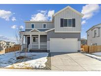 Two-story house with gray siding, white trim, and a two-car garage at 10062 Quari St, Commerce City, CO 80022