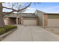Charming townhome featuring an attached garage, well-maintained landscaping, and a private driveway at 4825 S Ammons St # 113, Littleton, CO 80123