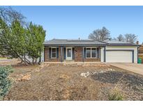 Charming single story home with brick accents and solar panels in a quiet neighborhood with a manicured front yard at 17148 E Evans Dr, Aurora, CO 80013