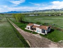 Inviting exterior of home featuring well-kept yard and mountain views at 8602 N 39Th St, Longmont, CO 80503