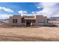 Charming southwestern home with unique architectural details, desert landscape, and bright turquoise accents at 8602 N 39Th St, Longmont, CO 80503