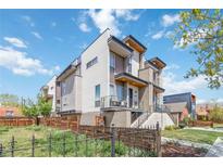 Modern townhome featuring a sleek design with a balcony, contemporary finishes, and professionally landscaped yard at 2409 Court Pl, Denver, CO 80205