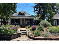 Charming home with a lush front yard and colorful, landscaped garden beds adding curb appeal at 4824 Knox Ct, Denver, CO 80221