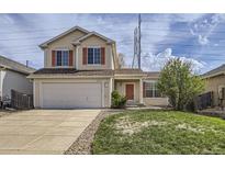 Charming two-story home featuring red shutters, a two-car garage, and a well-maintained front yard at 22030 Hill Gail Way, Parker, CO 80138