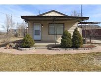 Charming single story home with a covered porch and landscaped front yard in a quiet neighborhood at 5660 Olive St, Commerce City, CO 80022