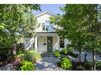 Charming home featuring a quaint covered porch with lush front yard landscaping and pea gravel walkway at 4508 Lowell Blvd, Denver, CO 80211