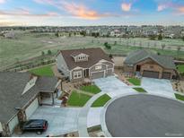 Beautiful neighborhood aerial view of a home with a three car garage and well maintained landscaping at 23696 E Del Norte Pl, Aurora, CO 80016