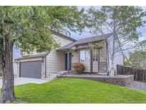 Charming two-story home with a well-maintained lawn and a two-car garage, offering great curb appeal at 11395 E 116Th Dr, Commerce City, CO 80640