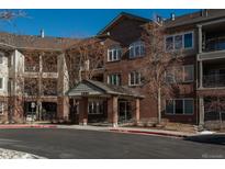 Brick building exterior with landscaping and parking at 2896 W Riverwalk Cir # 204, Littleton, CO 80123