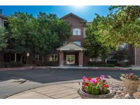 Attractive brick building with well-maintained landscaping and inviting entrance at 2896 W Riverwalk Cir # 204, Littleton, CO 80123