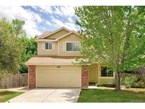 Charming two-story home with a well-manicured lawn, brick accents, and an attached two-car garage at 4860 W 125Th Ave, Broomfield, CO 80020