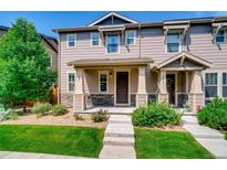 Two-story townhome with front porch and landscaping at 1567 S Dallas Cir, Denver, CO 80247