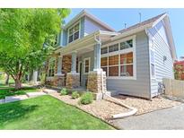 Beautiful home with a stone porch and well-maintained front yard landscaping at 14214 Lakeview Ln, Broomfield, CO 80023