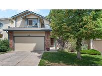 Charming two-story townhouse featuring a well-maintained lawn and attached garage at 2181 E Phillips Ln, Centennial, CO 80122