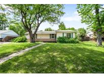 Charming ranch-style home featuring a spacious front yard with mature tree coverage at 4616 E Yale Ave, Denver, CO 80222