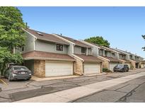 Exterior shot of townhomes with attached garages and well-maintained landscaping at 8795 W Cornell Ave # 1, Lakewood, CO 80227