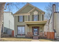 Charming two-story home featuring a covered front porch and classic architectural details at 2650 Perry St, Denver, CO 80212