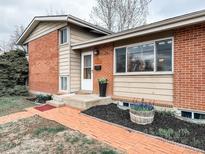 Charming brick home with inviting front yard and well-maintained landscaping at 10755 W 60Th Ave, Arvada, CO 80004