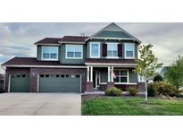 Charming two-story home with a well-maintained lawn and a three-car attached garage at 6892 Turnstone Ave, Castle Rock, CO 80104