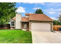 Charming single-Gathering home with a manicured lawn, two-car garage, and stone accents at 5101 E 122Nd Cir, Thornton, CO 80241