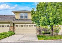 Charming home featuring a well-maintained front yard and a two-car garage with decorative windowpane accents at 3000 E 112Th Ave # 86, Northglenn, CO 80233