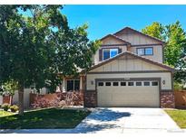 Charming two-story home featuring a two-car garage, mature trees, and a well-maintained lawn at 4788 Laurelglen Ln, Highlands Ranch, CO 80130