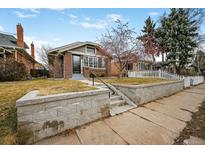 Charming brick home with manicured front yard and stone retaining wall at 460 S Sherman St, Denver, CO 80209