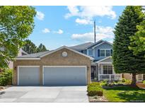 Charming two-story home with a brick-accented garage and well-manicured front yard at 5134 S Ouray Ct, Centennial, CO 80015