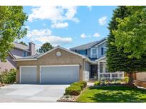 Charming two-story home with a manicured front yard, a two-car garage, and a welcoming entryway at 5134 S Ouray Ct, Centennial, CO 80015