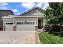 Charming home featuring a three-car garage and inviting front yard landscaping at 3406 Quicksilver Rd, Frederick, CO 80516
