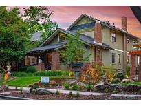 Charming two-story home featuring a landscaped front yard, brick accents, and classic architectural details under a beautiful sunset sky at 1121 S Williams St, Denver, CO 80210