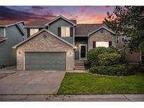 Charming two-story home featuring a brick and siding exterior, a two-car garage, and a well-maintained front yard at 359 Wessex Cir, Highlands Ranch, CO 80126