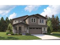 Charming two-story home with covered porch, neutral siding, well manicured lawn, and an attached two-car garage at 8338 Snake River St, Littleton, CO 80125
