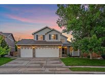Charming two-story home with a three-car garage and well-manicured lawn at 10723 W 54Th Pl, Arvada, CO 80002