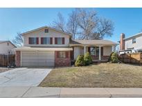 Charming two-story home with brick accents, a two-car garage, and a well-maintained front yard at 6823 Coors St, Arvada, CO 80004