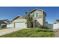 Charming two-story home showcasing a well-maintained lawn, two-car garage, and inviting curb appeal at 529 Beckwourth, Fort Lupton, CO 80621